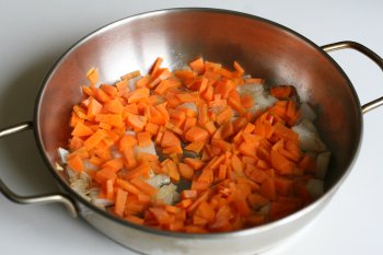 положить морковь в сковороду с луком