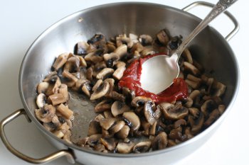 добавить томат-пасту к грибам, хорошо перемешать и прогреть